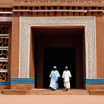 National Museum of Mali**

"Exterior of the National Museum of Mali in Bamako, showcasing traditional Malian architecture. People in appropriate attire are entering and exiting. Daytime. Safe for work, appropriate content, fully clothed, professional architecture photography, high quality, perfect anatomy, correct proportions, natural pose, family-friendly."

**